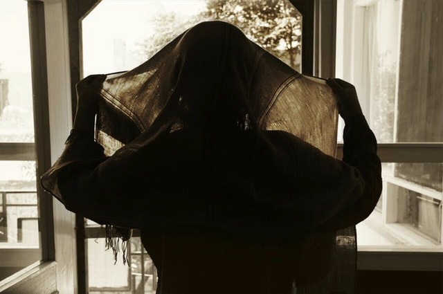 Silhouette of an Afghan woman wearing a head covering.